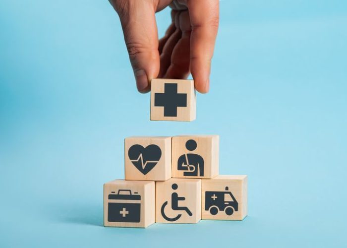 hand arranging wood block stacking with the healthcare medical icon. health insurance health concept